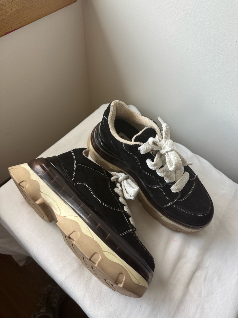 Steve Madden Evolved Sneaker in black with a chunky cream and tan platforms 9.5